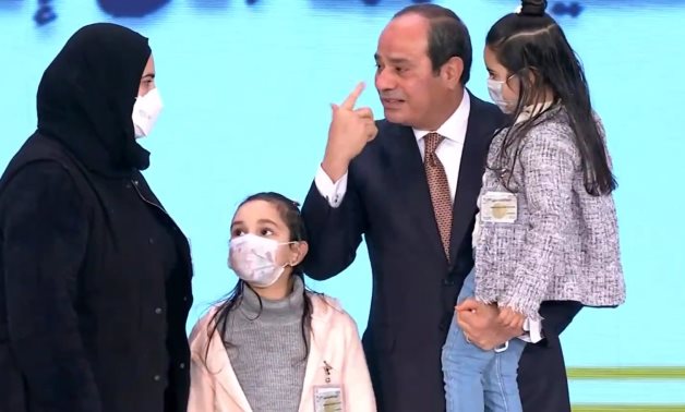 Sisi with the wife and children of one of the military officers who died countering terrorism on Martyr's Day in March 2021 - Still image