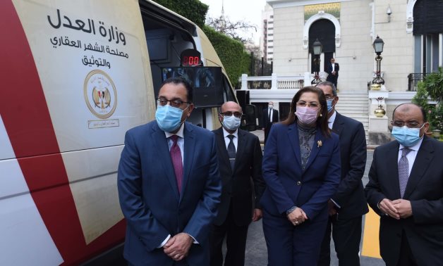 Prime Minister Mostafa Madbouli and Minister of Planning and Economic Development checking mobile unit offering documentation services. Press Photo