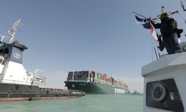 File- Panama-flagged Ever Given ship is pulled by giant tugboats to harbor in the Great Bitter Lakes in Ismailia- press photo