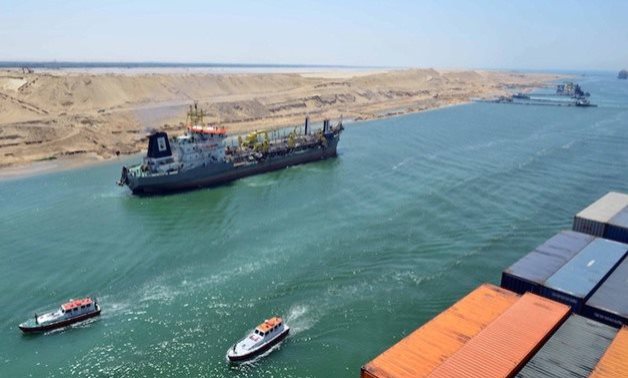 A ship is passing through the Suez Canal after refloating the Ever Given vessel- Press photo