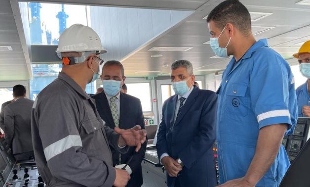 Head of Suez Canal Authority Admiral Osama Rabie listens to a clarification of how the Mohab Mamish dredger operates - Egypt Today/ samar Samir