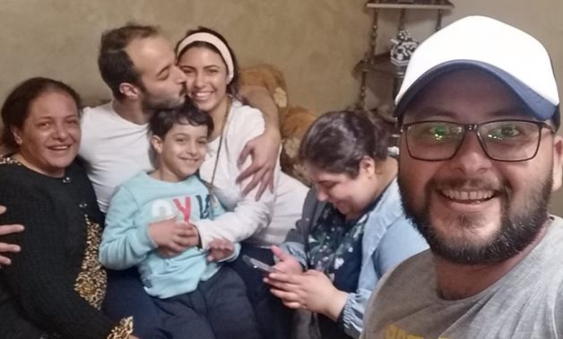 Egyptian journalist Hossam El-Sayyad kisses the cheek of his wife, Solafa Magdy, after their release – Photo published by Taghred Zahran, Solafa’s mother