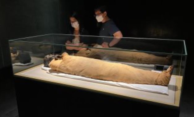 Tourists watch on awe one of the ancient Egyptian Royal Mummies - ET