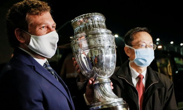 Alejandro Dominguez, president of CONMEBOL, with Chinese Ambassador to Uruguay Wang Gang hold the Copa America trophy, Reuters 