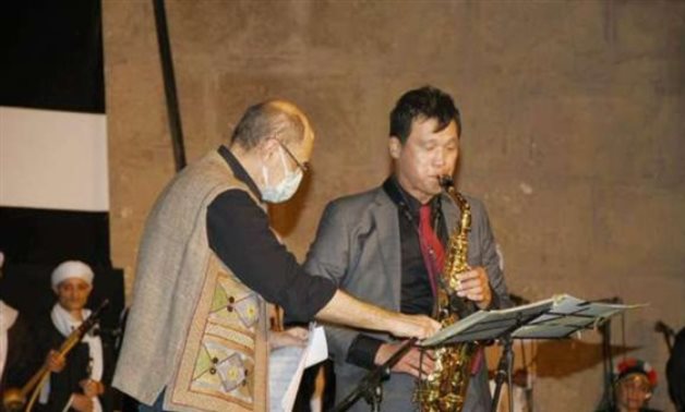 S. Korean Ambassador to Egypt playing the saxophone during the festival's opening ceremony - Min . of Culture