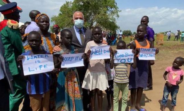 Minister Mohamed Abdel Aty posing with children while inaugurating an underground water treatment plant built by Egypt in South Sudan's Lemon Mountain on June 23, 2021. Press Photo 