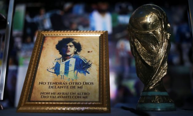 A picture of Diego Maradona and a replica of the World Cup trophy are pictured on an altar at the first Mexico's church, Reuters