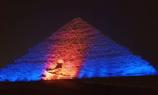 Great Pyramid of Cheops lit up in blue and orange in recognition of World Hepatitis Day - Min. of Tourism & Antiquities