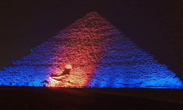 Egypt’s Giza pyramids and Saladin Citadel lit up in blue and orange to celebrate the World Hepatitis Day on Wednesday- press photo