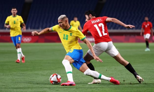  Egypt's Akram Tawfik and Brazil's Richarlison in action during the game