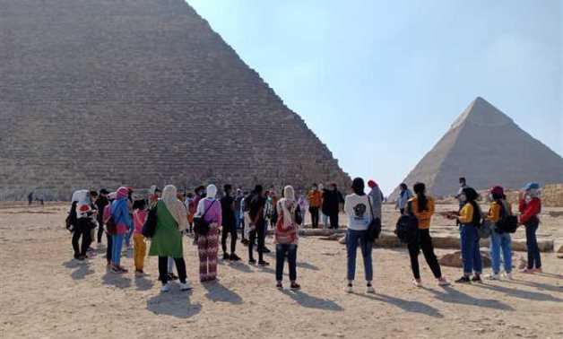 Participants of the previous "Ahl Masr" project during a visit to the Great Giza Pyramids - ET