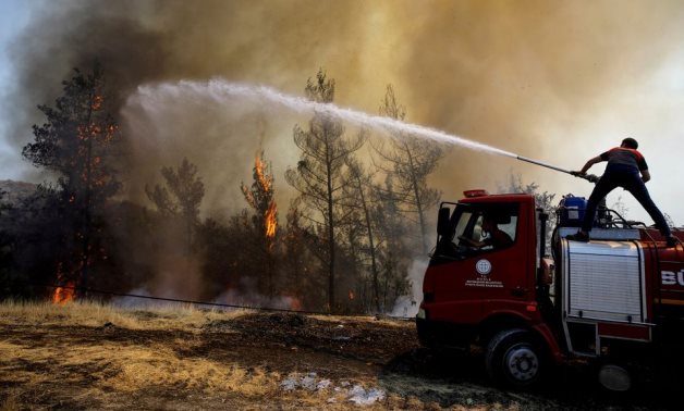 A firefighter tries to extinguish a wildfire near Marmaris, Turkey, August 1, 2021. Reuters