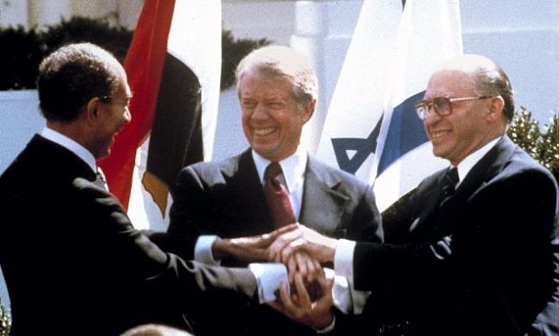  Sadat, Carter, Begin hold hands on the North Lawn of the White House as they sign the peace treaty between Egypt and Israel, on March 26, 1979. (AP/Bob Daugherty)