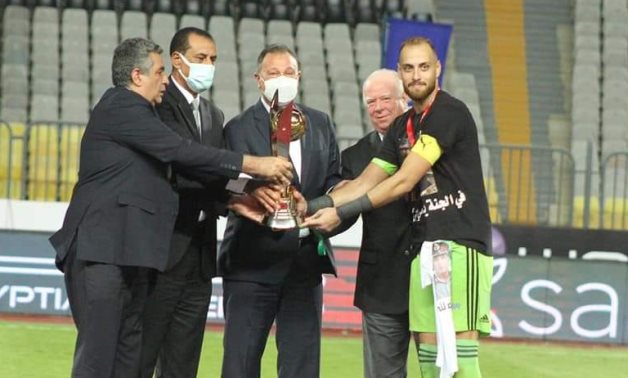 El Gaish captain Mohammed Bassam receives the Super Cup trophy 