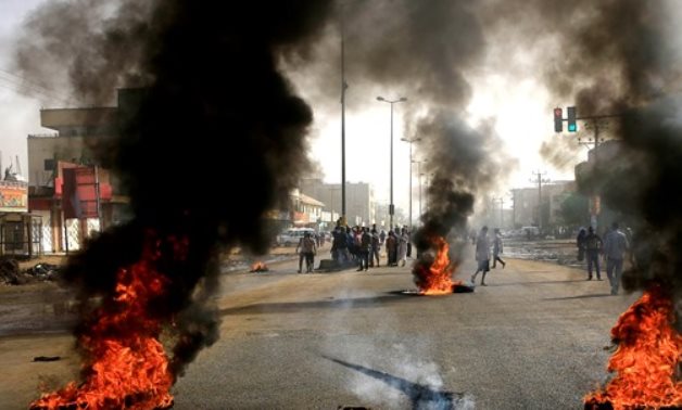 File- Sudanese protesters use burning tyres to erect a barricade on a street, demanding that the country's Transitional Military Council hand over power to civilians, Khartoum, Sudan June 3, 2019. REUTERS/StY