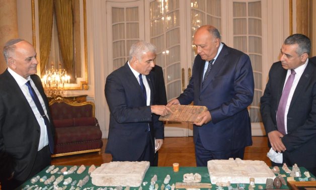 In the presence of Egypt's FM Sameh Shoukry and Israeli counterpart Yair Lapid in Cairo on Thursday, Egypt received 95 smuggled Egyptian artifacts that were seized by the Israeli authorities- press photo.