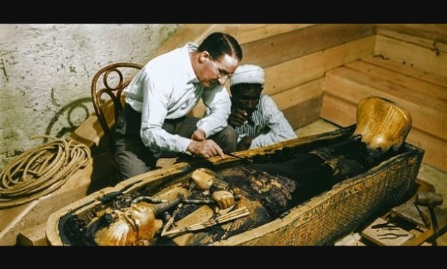 FILE - Howard Carter inspecting Tutankhamun's sarcophagus 