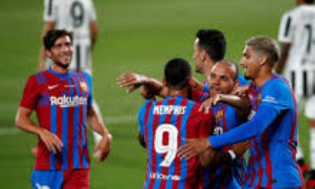 Barcelona players celebrate scoring, Reuters