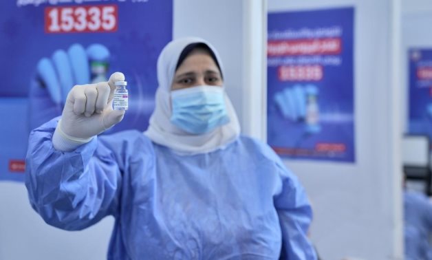 FILE - An Egyptian medical worker holds a coronavirus vaccine vial - UNICEF