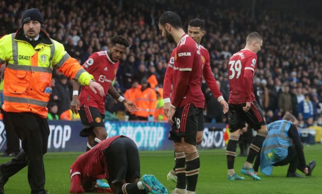 Manchester United's Anthony Elanga reacts after being struck in the head by an object as they celebrated their third goal scored by Fred Action Images via Reuters/Lee Smith