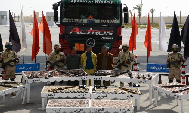 Elements of the Egyptian Border Guard Force posing with smugglers and confiscated arms at Suez Canal on February 23, 2022. Press Photo