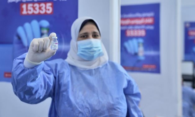 FILE - An Egyptian medical worker holds a coronavirus vaccine vial - UNICEF