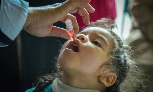 A child taking a polio vaccine dose in Egypt. Egyptian Ministry of Health