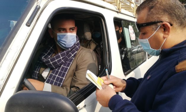 FILE - Officer checks the driving license of a driver in Cairo Jan. 3, 2021 - Egypt Today