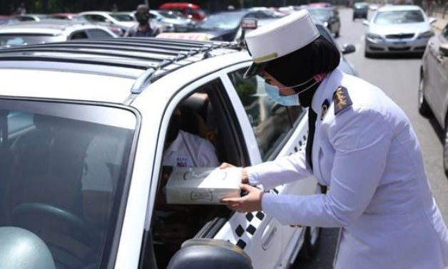 Egypt’s Police distribute flowers, gifts to people on the 1st day of Eid Al Fitr- press photo