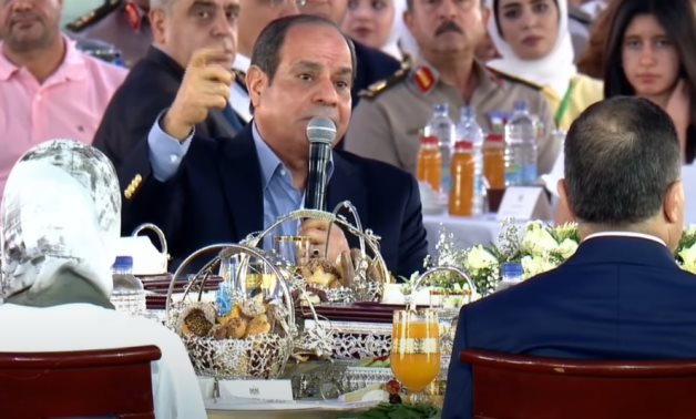 President Abdel Fattah al-Sisi gestures with his hand as if he is shooting the gun to show how Khairat el-Shater threatened him, May 2, 2022 - Youtube still