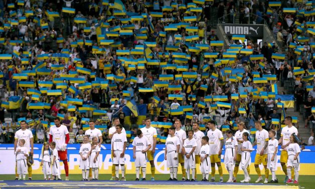 Ukraine players line up with young mascots before the match REUTERS/Thilo Schmuelgen
