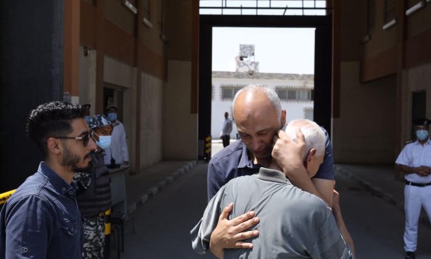 File- An Egyptian prisoner was released and hugged his relative outside a prisoner- Egypt Today