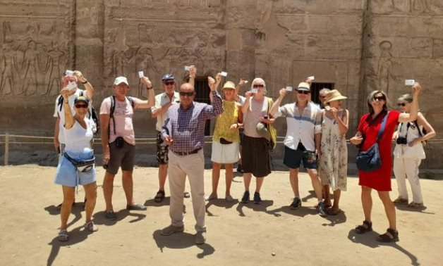 A group of tourists in Egypt holding their electronic tickets - Min. of Tourism & Antiquities