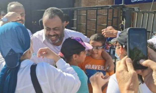 Lawyer and Activist Mohamed Ramadan hugging his family in front of prison gates after release on July 25, 2022. Facebook  
