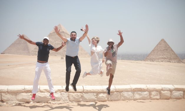 File: Egyptian International star Mohamed Karim visits the Pyramids, Muizz street with ‘A Day to Die’ cast.