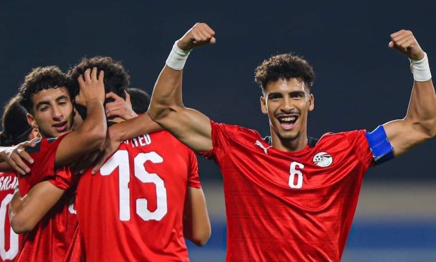 The Egyptian players celebrate scoring a goal against Algeria 