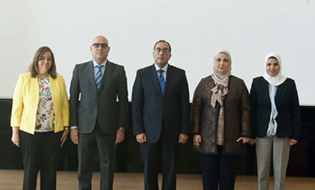 Prime Minister Mostafa Madbouli posing with ministers and officials after signing an agreement allowing civilian victims of terrorism access to subsidized housing. August 4, 2022. Press Photo