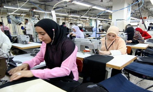 FILE - Egyptian women work in a factory - Reuters