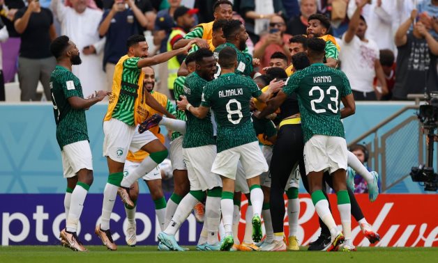 Saudi Arabia midfielder Salem Al-Dawsari is congratulated by teammates after scoring a goal against Argentina during a group stage match during the World Cup. Mandatory Credit: Yukihito Taguchi-USA TODAY Sports