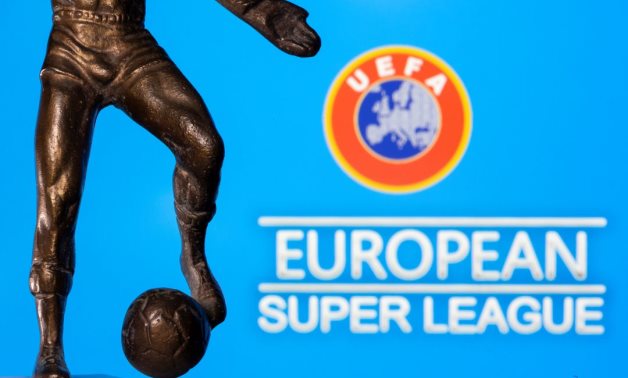 A metal figure of a football player with a ball is seen in front of the words "European Super League" and the UEFA logo in this illustration taken April 20, 2021. REUTERS/Dado Ruvic/Illustration