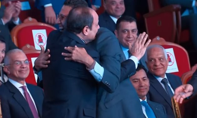 President Sisi shares a hug with one of the people of determination during the ceremony after welcoming his requests