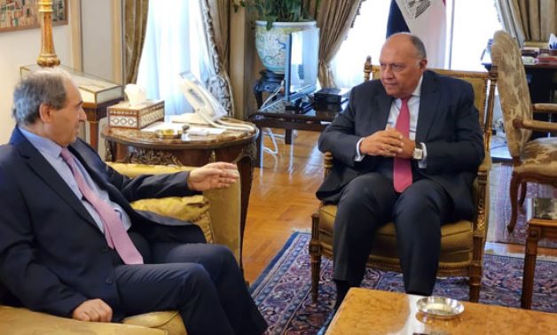 Egypt's Foreign Minister Sameh Shoukry (L) receives his Syrian counterpart Fayssal Mekdad (R) in Cairo on Saturday