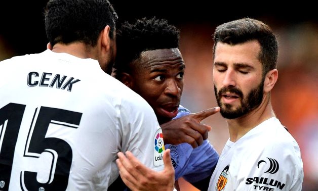 Real Madrid's Vinicius Junior gestures towards a fan after witnessing abuse as Valencia's Jose Gaya and Cenk Ozkacar attempt to restrain him REUTERS/Pablo Morano/File Photo