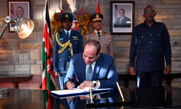 Egypt's President Abdel Fattah El-Sisi leaves a message to Kenyan President Ruto in the visitor's book - Egyptian Presidency