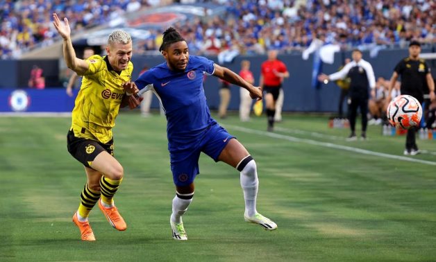 Borussia Dortmund defender Julian Ryerson (26) battles for the ball against Chelsea forward Christopher Nkunku (45) during the first half at Soldier Field. Mandatory Credit: Jon Durr-USA TODAY Sports