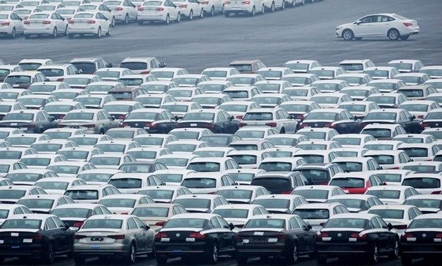 FILE PHOTO: Newly manufactured cars are seen at the automobile terminal in the port of Dalian, Liaoning province, China July 9, 2018. Reuters
