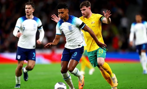 England's Ollie Watkins in action with Australia's Ryan Strain Action Images via Reuters/Matthew Childs