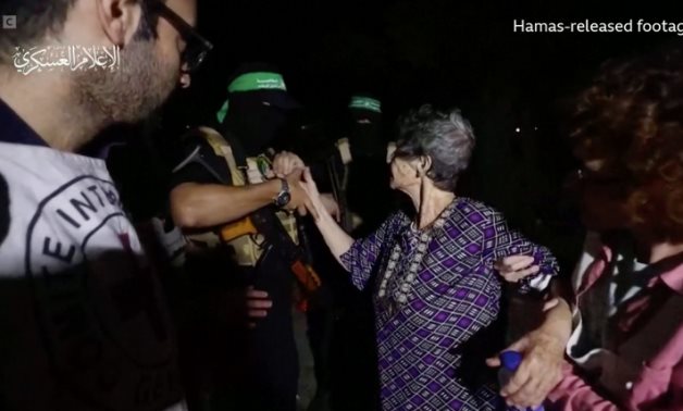 Yocheved Lifschitz shakes hands with Hamas militant and saying to him goodbye- screenshot from a video footage released by Hamas