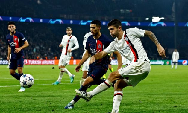 AC Milan's Christian Pulisic in action with Paris St Germain's Achraf Hakimi REUTERS/Gonzalo Fuentes