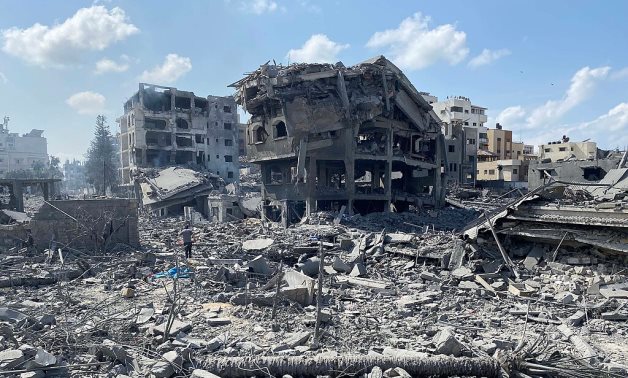 Palestinians inspect the damage following an Israeli airstrike on the El-Remal aera in Gaza City on October 9, 2023 - WAFA